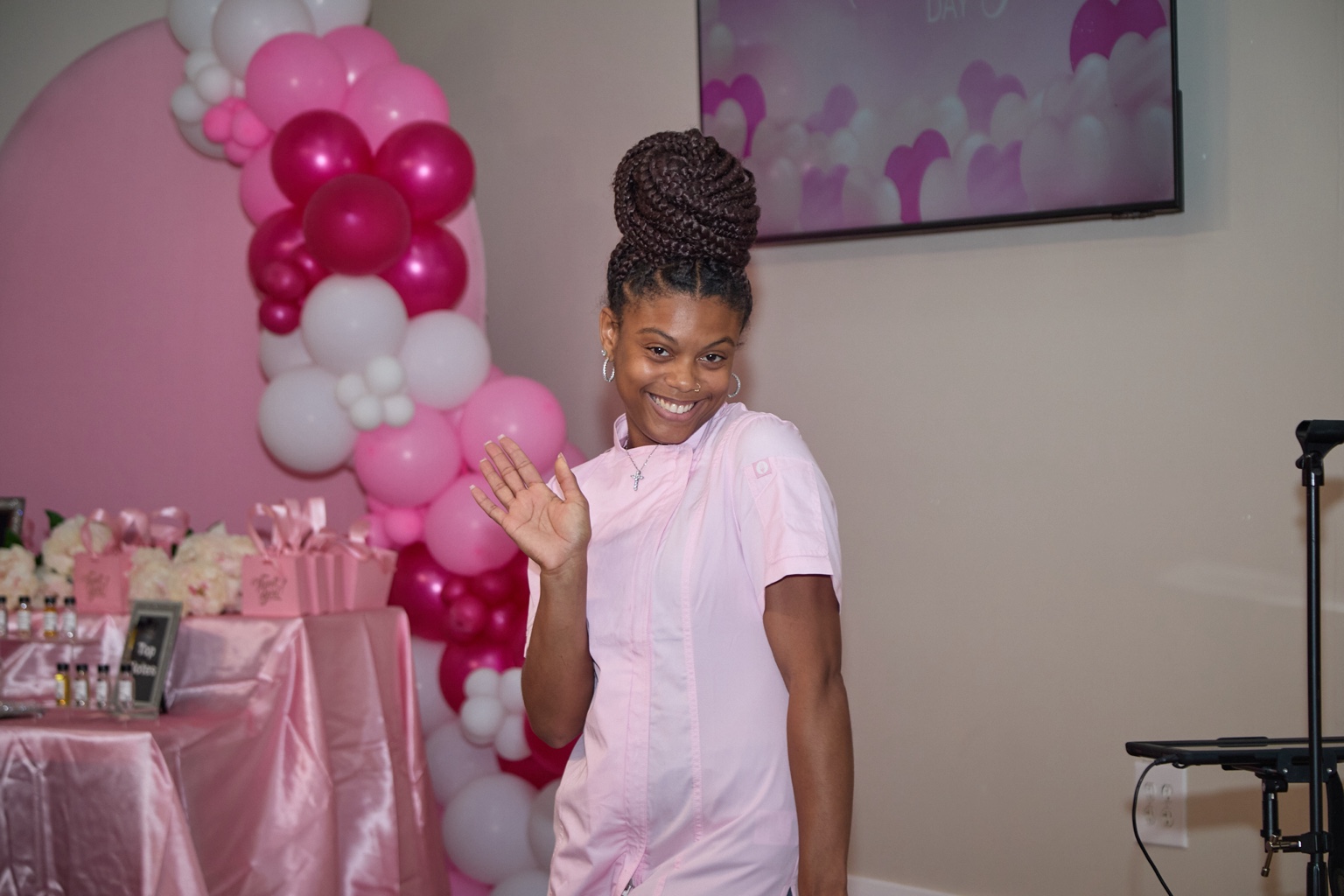 Chef Kai smiling at a pink themed celebration