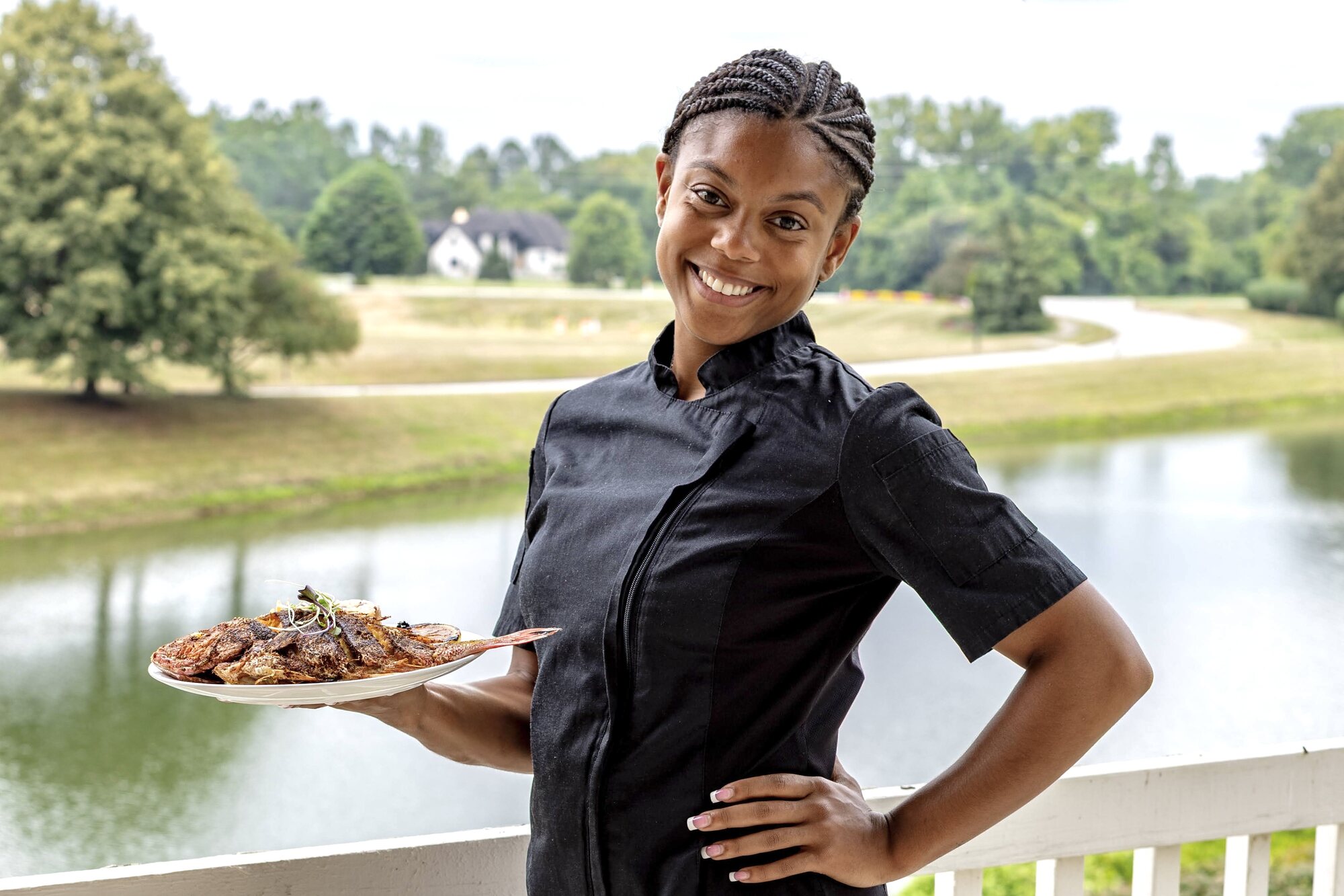 Chef Kai Smith presenting a plated meal