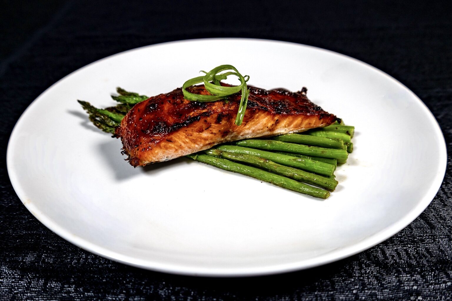 Glazed salmon and asparagus on a white platter