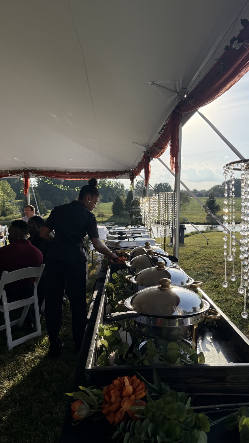 Chef Kai tending an elegant outdoor wedding buffet