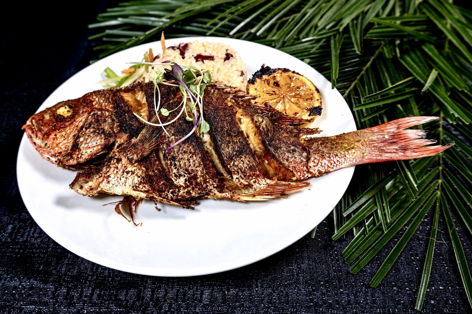 Whole snapper prepared for a dinner experience